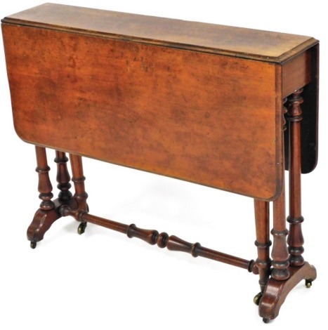 A Victorian mahogany Sutherland table, with rounded top on turned legs, joined by a cylindrical stretcher, terminating in castors, 74cm high, 84cm wide.