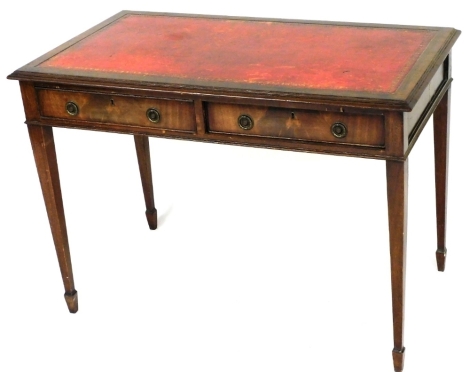 A 20thC mahogany writing table, with one piece tooled red leather top above two frieze drawers, on tapering legs terminating in spade feet, 77cm high, 105cm wide, 59cm deep.