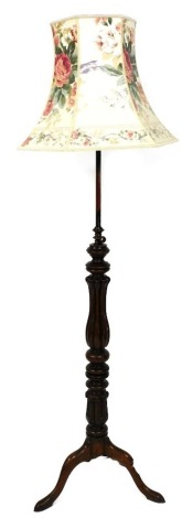 A mahogany and copper adjustable standard lamp, with a turned lappet carved fluted column, tripod base with pad feet, 184cm high to include shade.