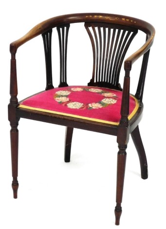 A Victorian mahogany and marquetry tub shaped chair, with a pierced splat, wool work padded seat decorated with flowers, on turned legs.