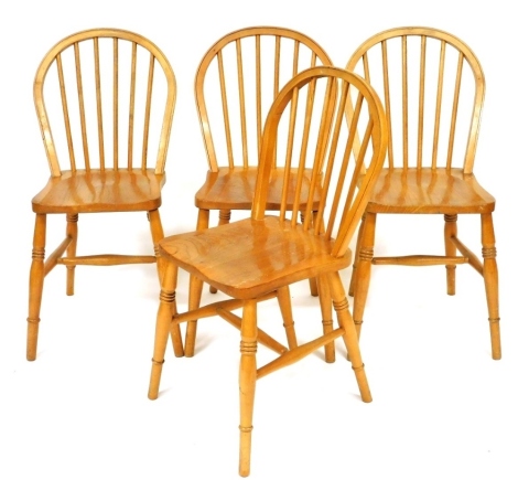 A set of four pale ash and elm Windsor type dining chairs.