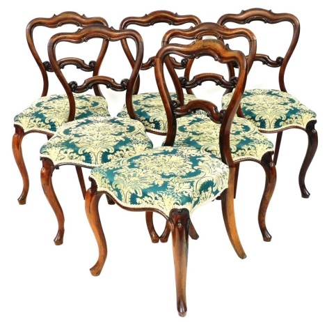 A set of six Victorian rosewood balloon back dining chairs, with horizontal scroll splats, with overstuffed seats, in turquoise and cream floral material, on cabriole front legs, 93cm high. (6)