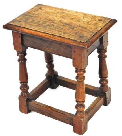 A Jacobean style oak joint stool, with plain rectangular top raised on baluster supports, terminating in block feet joined by block stretchers, 48cm high, 42cm wide, 26cm deep.