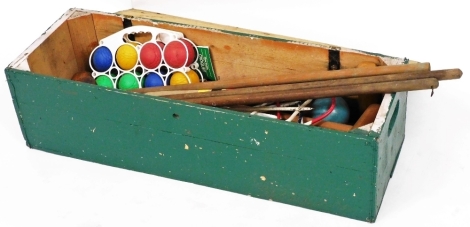 A croquet set, in a green painted box, 89cm wide.