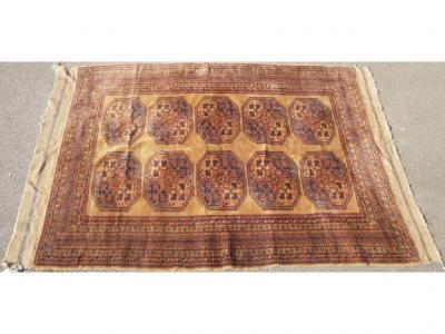 An Afghan beige ground rug