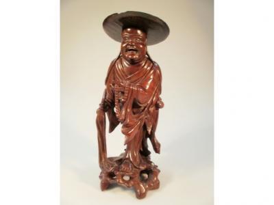 A late 19thC Chinese carved root wood figure of a sage