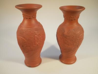 A pair of late 19thC Chinese red earthenware baluster vases with wandering