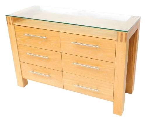A modern oak effect sideboard, with a glazed top, above six drawers each with chrome handles, 81cm high, 120cm wide, 44cm deep.