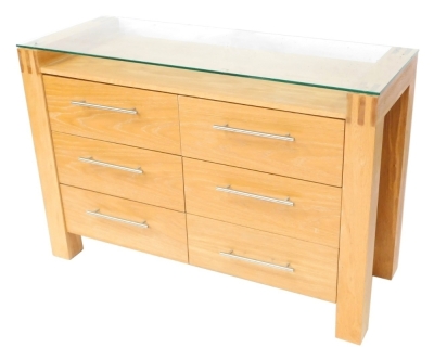 A modern oak effect sideboard, with a glazed top, above six drawers each with chrome handles, 81cm high, 120cm wide, 44cm deep.