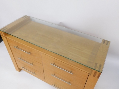 A modern oak effect sideboard, with a glazed top, above six drawers each with chrome handles, 81cm high, 120cm wide, 44cm deep. - 2