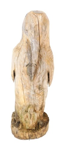 A carved driftwood figure of a penguin and child, 92cm high.