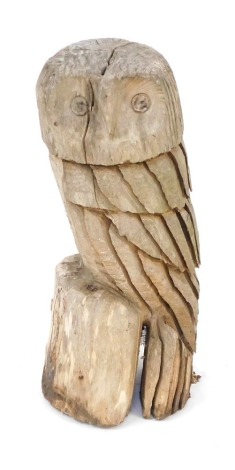 A carved driftwood figure of a seated owl, on perch, 60cm high.
