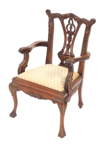 A mahogany child's chair, in the Chippendale style with cream drop-in seat, 52cm high, 33cm wide. The upholstery in this lot does not comply with the 1988 (Fire & Fire Furnishing) Regulations, unless sold to a known exporter or upholsterer it will be cut 