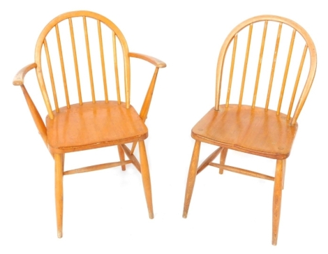 Two Ercol pine stick back kitchen chairs, to include one carver.