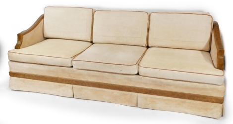An Art Deco pollard oak framed three seater sofa, with cream upholstery, possibly American, 80cm high, 212cm wide, 80cm deep. The upholstery in this lot does not comply with the 1988 (Fire & Fire Furnishing) Regulations, unless sold to a known exporter or
