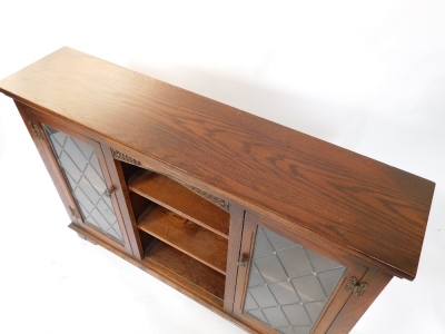 A pair of Old Charm oak cabinets, with two astragal glazed doors and central bookshelf section, on bracket feet, 83cm high, 121cm wide, 28cm deep. - 3