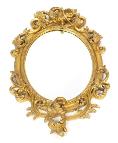 An early 20thC gilt gesso wall mirror, with rococo scrolled outer detailing and intertwined cherub figure, with an oval panel, later backed, 88cm high, 59cm wide.