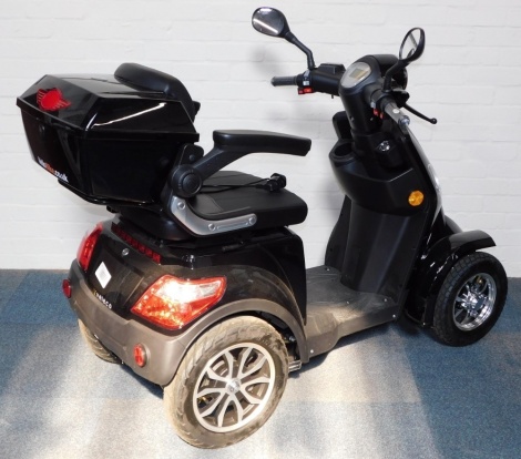 A Veleco Luxury electric scooter mobility scooter, with charger pack.