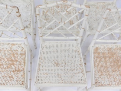 A set of six distressed cream painted dining chairs, each with simulated bamboo supports, white painted with cane seats. - 4