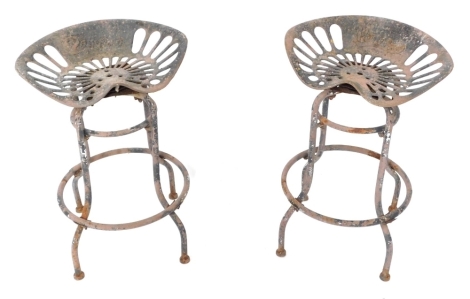 A pair of Pan and Botany swivel metal tractor seat bar stools, 65cm high, seats 47cm wide.