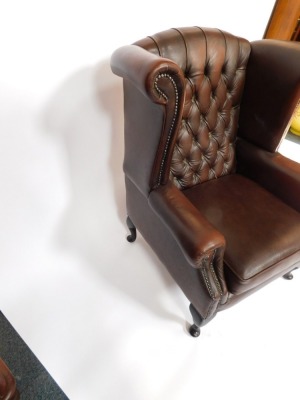 A brown leather Thomas Llyod Chesterfield wingback armchair, with button and stud detailing on mahogany out splayed legs, 102cm high, 76cm wide, 65cm deep. - 3