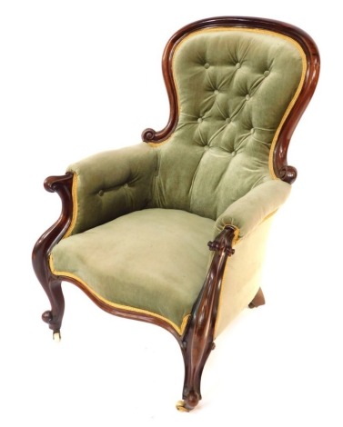 A Victorian mahogany spoon back armchair, the shield back with button detailing, 102cm high, 68cm wide, 60cm deep.