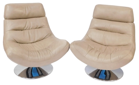 A pair of taupe leather swivel lounge chairs, each with chrome base, approx 100cm high, 85cm wide.