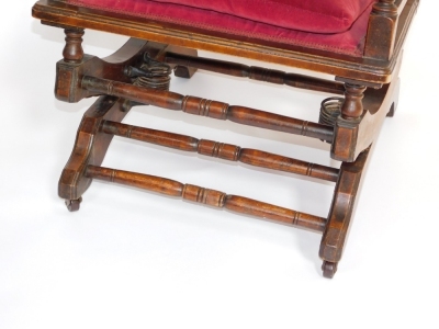 An early 20thC American walnut and upholstered rocking chair, with red upholstery, 113cm high, 55cm wide, 66cm deep. - 3