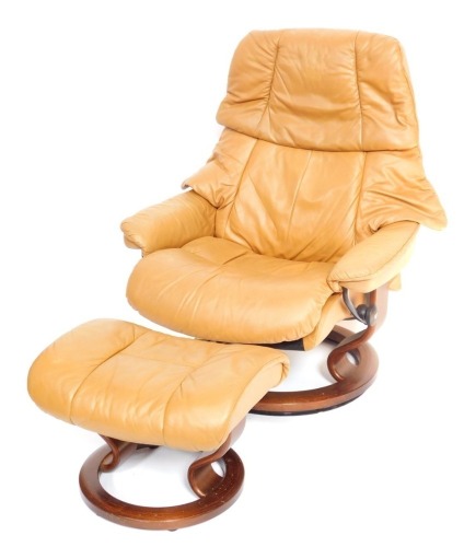 A Stressless tan leather swivel armchair and footsool.