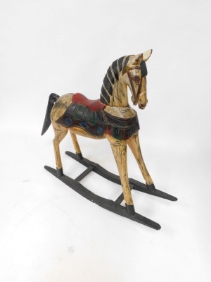 A painted pine rocking horse, with applied red saddle in Eastern design, on a blackened base, 95cm high, 85cm wide, 23cm deep. - 3