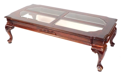 An Eastern hardwood coffee table, with cabriole shell capped legs, with four glass insets to top, 40cm high, 130cm wide, 64cm deep.