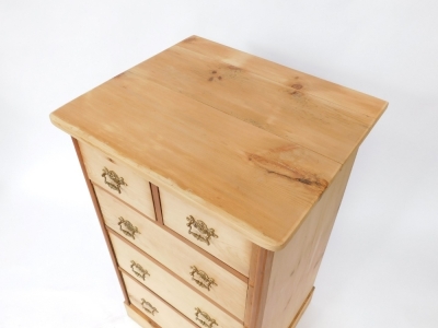 A stripped pine chest of drawers, with two short and three long drawers, with brass scroll handles, on bracket feet, 110cm high, 87cm wide, 57cm deep. - 2