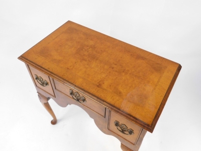 A Georgian style walnut lowboy, with one short and two deep drawers above a shaped apron, raised on shell carved cabriole legs, 59cm high, 74cm wide, 41cm deep. - 2