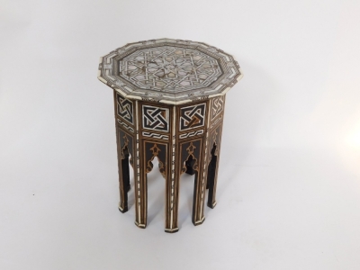 An early 20thC Damascus type mother of pearl inlaid table, the top raised on panelled sides, with mihrabs, on tapering straight legs, possibly retailed by Liberty, 51cm high, 41cm wide. (AF) - 3