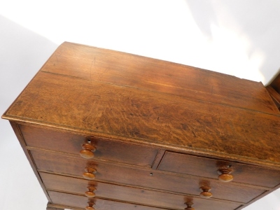 A George III oak chest of two short over three long graduated drawers, raised on outswept feet, 103cm high, 109cm wide, 53.5cm deep. - 2