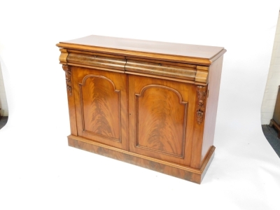 A Victorian flame mahogany side cabinet, with two cushion drawers, over a pair of panelled doors, flanked by foliate carving, raised on a plinth base, 98cm high, 127cm wide, 48cm deep. - 2