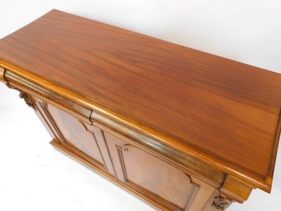 A Victorian flame mahogany side cabinet, with two cushion drawers, over a pair of panelled doors, flanked by foliate carving, raised on a plinth base, 98cm high, 127cm wide, 48cm deep. - 3