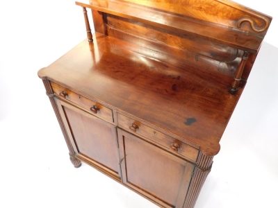 A late Regency mahogany chiffonier, the pendimented back with a single shelf raised on turned columns, over two drawers above a pair of panelled doors, raised on fluted columns and feet, 123cm high, 91cm wide, 48cm deep. - 2