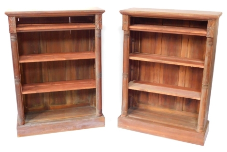 A pair of Victorian mahogany open bookcases, each with three pine shelves, flanked by turned demi pilasters, raised on plinth bases, 122cm high, 89cm wide, 33.5cm deep.