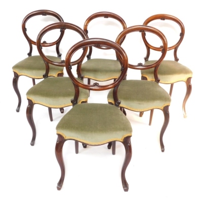 A set of six Victorian rosewood balloon back dining chairs, the overstuffed seats upholstered in green draylon, raised on cabriole legs.