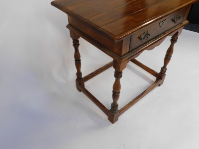 A 17thC style walnut side table, with a four plank top, over a frieze drawer, shaped apron raised on baluster turned columns united by a boxed stretcher, 52cm high, 74cm wide, 49cm deep. - 3