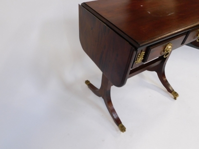 A Regency style mahogany sofa table, with two frieze drawers, raised on outswept supports, brass capped castors, united by a straight stretcher, 83cm high, 84cm wide, 38cm extended, 49cm deep. - 3