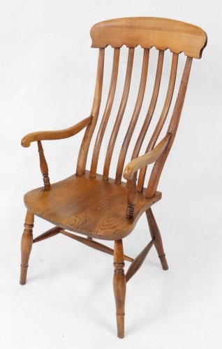 A 19thC beech and elm lath back kitchen chair, with solid saddle seat, raised on turned legs united by a H framed stretcher.