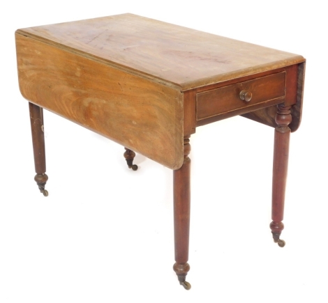 A late Georgian mahogany Pembroke table, with frieze drawer, raised on turned legs, brass capped on castors, 75cm high, 107cm wide, 57cm deep.