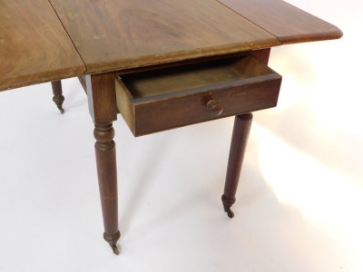 A late Georgian mahogany Pembroke table, with frieze drawer, raised on turned legs, brass capped on castors, 75cm high, 107cm wide, 57cm deep. - 3