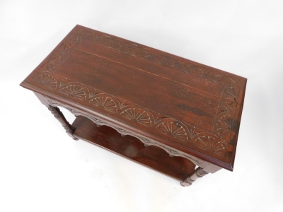 An Old Charm style oak rectangular coffee table, with carved sunburst decoration to top on frieze, raised on turned legs, united by an under tier, 70cm high, 91cm wide, 45cm deep. - 2