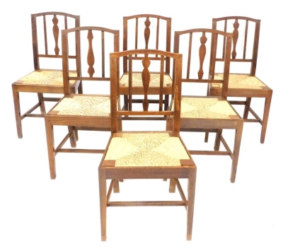 A set of six George III oak and rush seated dining chairs.