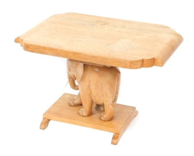 An Indian carved hardwood table, raised on an elephant support, 41cm high, 65cm wide, 42cm deep.