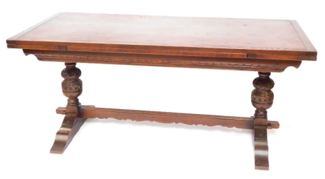 An oak refectory dining table, raised on carved cup and covered supports, and block feet united by a stretcher, 50cm high, 183cm wide, 91cm deep.