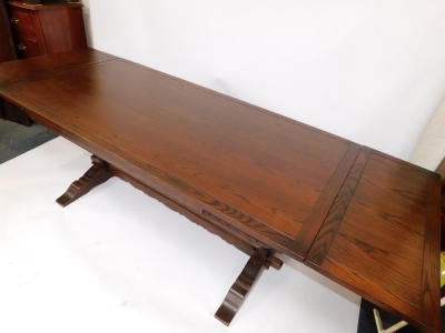 An oak refectory dining table, raised on carved cup and covered supports, and block feet united by a stretcher, 50cm high, 183cm wide, 91cm deep. - 4